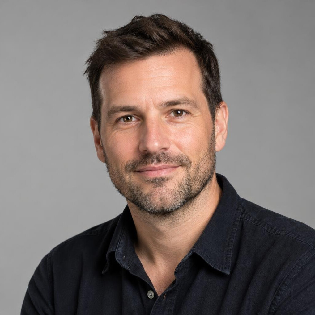 Portrait of a man with short dark hair and a light beard
