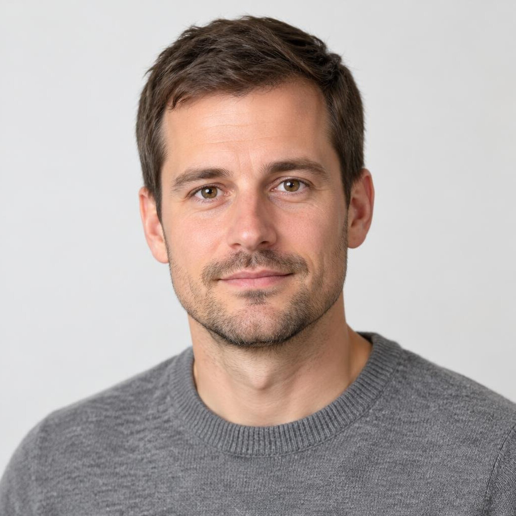 Portrait of a man with short hair and a calm expression